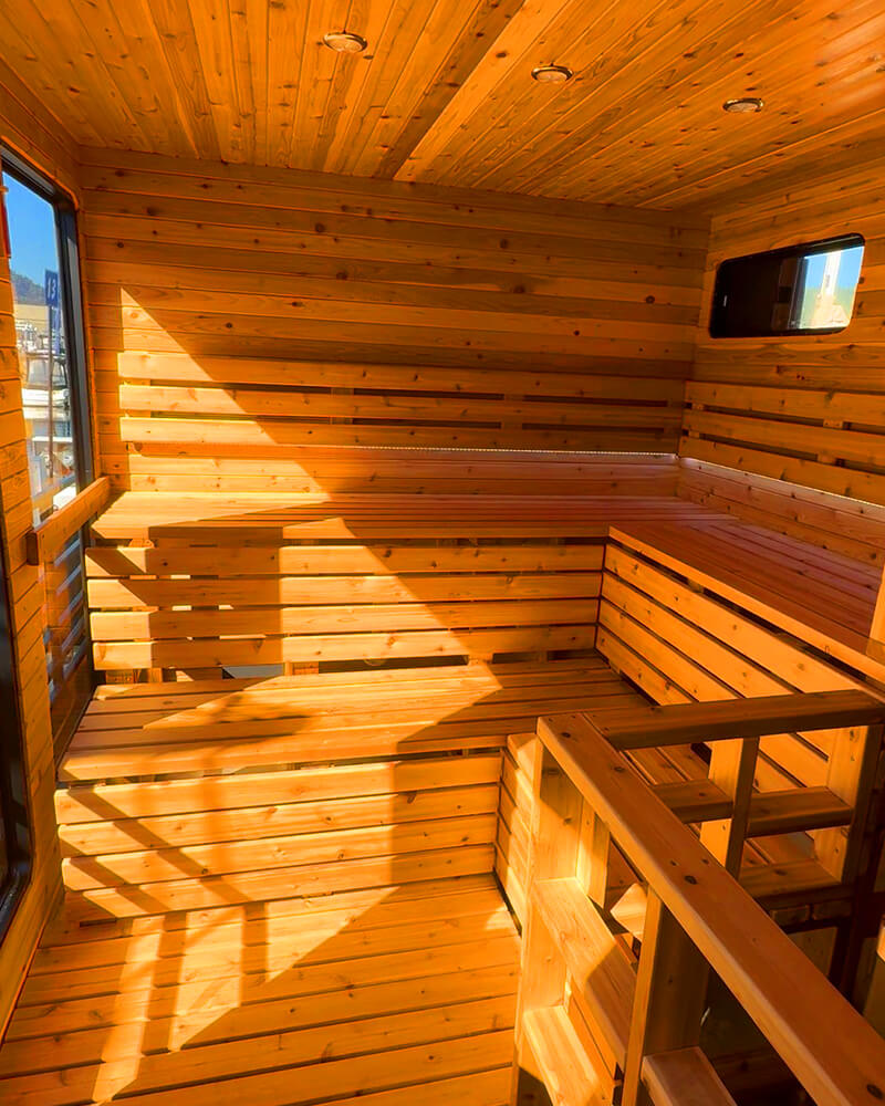 Detailed view of pristine cedar wood benches inside a floating sauna boat.