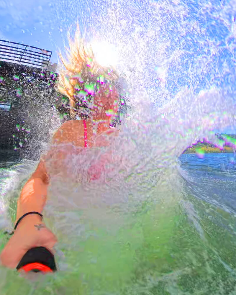 POV action selfie of a person splashing into the ocean from a sauna boat.