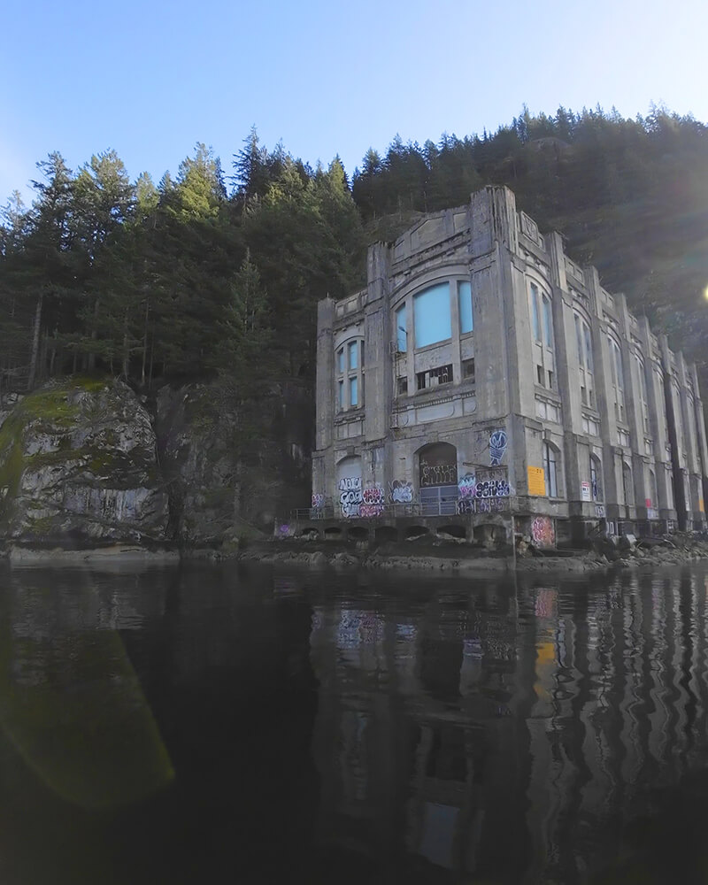 Historic stone powerhouses on the water viewed from the Hot Voyage sauna boat.