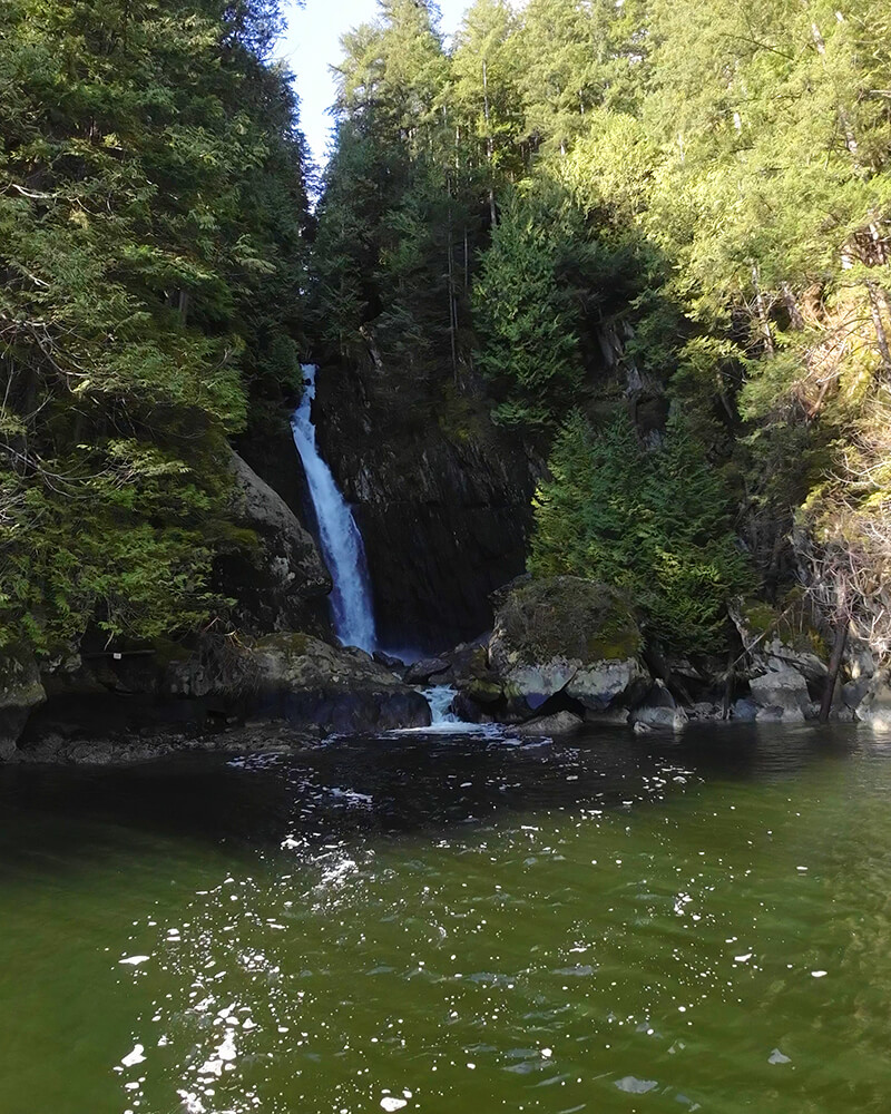 Close-up of Silver Falls cascading into the water viewed from a sauna boat.