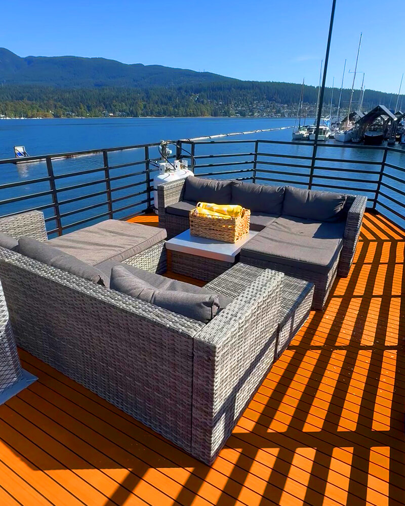 Rooftop lounge of the Hot Voyage sauna boat on a bright, sunny day.
